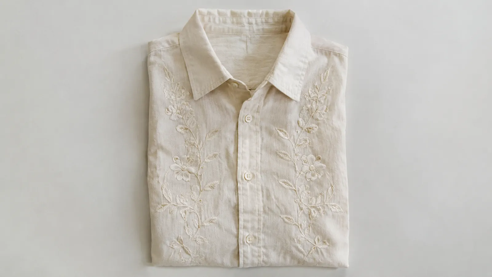 Finished embroidered shirt laid flat, stitching smooth with no puckered lines around the design